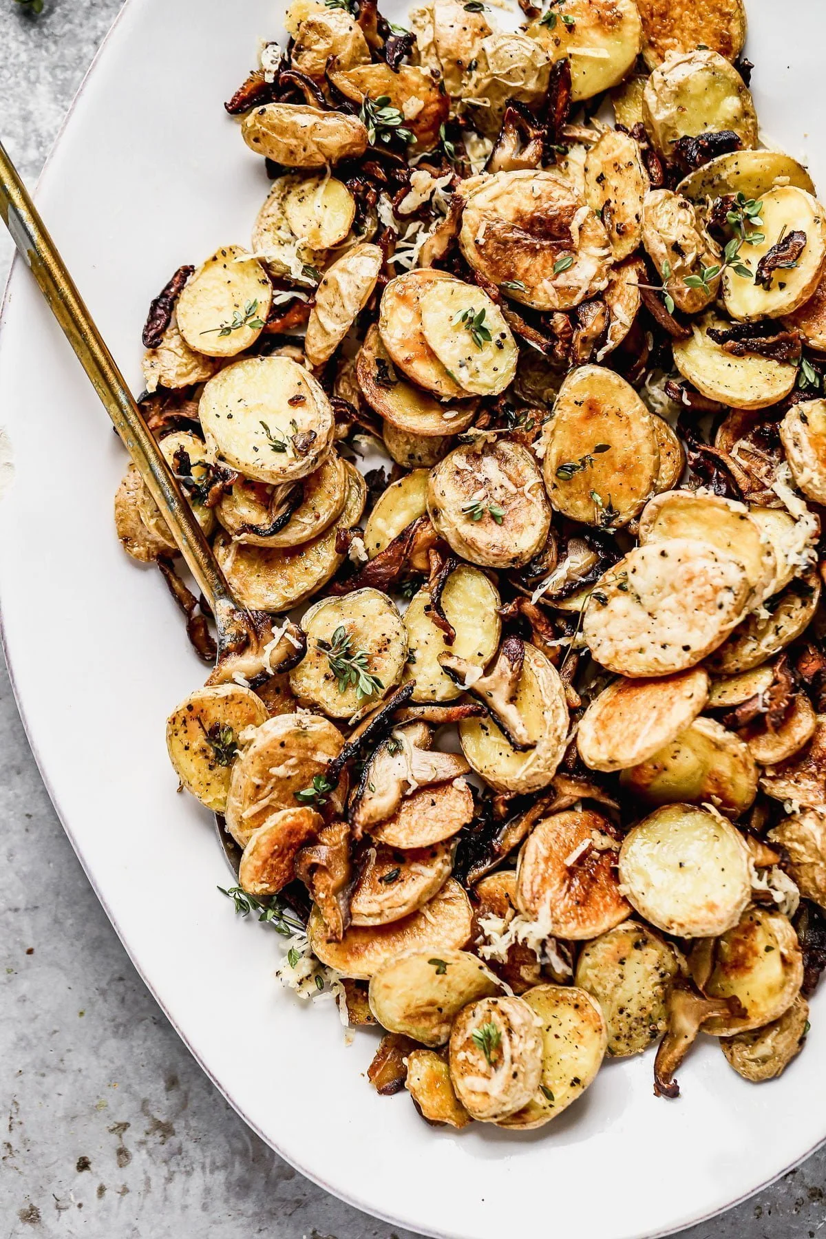 Crispy Parmesan Roasted Potatoes and Mushrooms, always. We roast buttery yukon gold potatoes and woodsy shiitake mushrooms until they're irresistibly crispy and golden, then toss them with nutty parmesan cheese and fresh thyme. Simple, but so delicious. &nbsp;