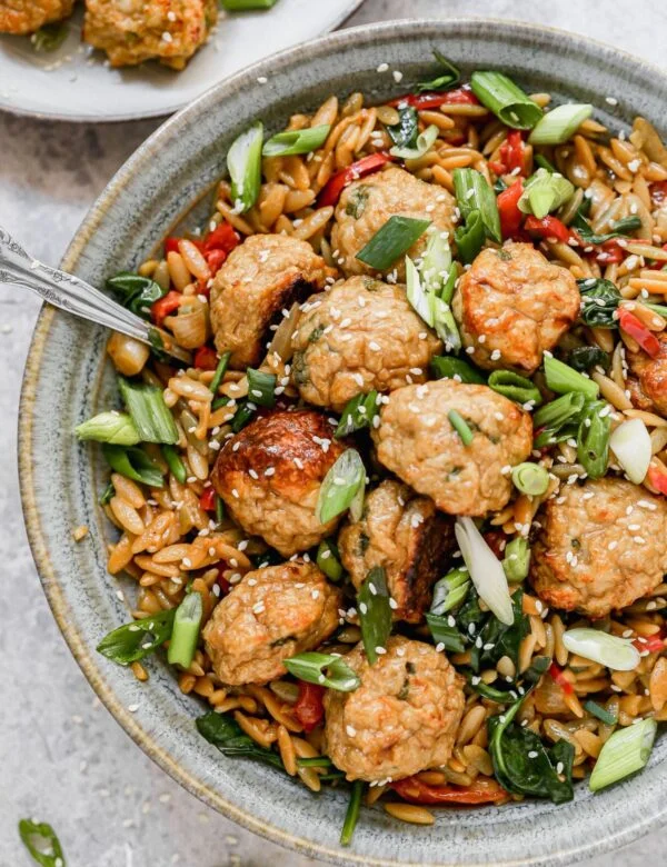 Our current favorite was to do meatballs: Asian Chicken Meatballs with Saucy Sesame and Hoisin Orzo. This fun spin on a classic pairs tender, garlic and ginger BAKED meatballs with an orzo full of veggies and an addictive sauce you'll want to lick with the a spoon. Prep ahead and eat later in the week! 