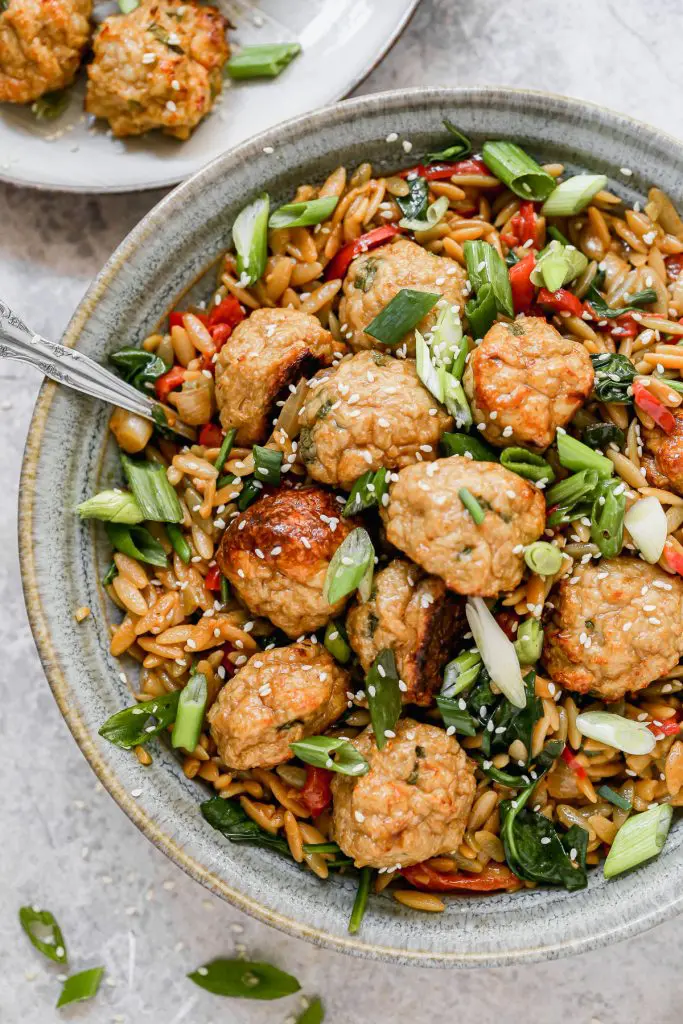 Our current favorite was to do meatballs: Asian Chicken Meatballs with Saucy Sesame and Hoisin Orzo. This fun spin on a classic pairs tender, garlic and ginger BAKED meatballs with an orzo full of veggies and an addictive sauce you'll want to lick with the a spoon. Prep ahead and eat later in the week!Â
