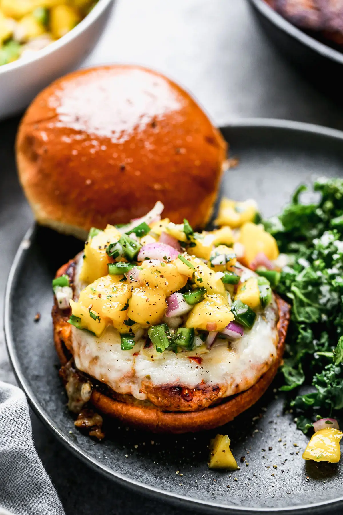 Packed with a homemade cajun seasoning, sweet onion, and seared until blackened and crisp on the edges and irresistibly juicy and moist on the inside, our Cajun Chicken Burgers are our new favorite way to do a burger. We smother the spicy patties with melty pepper jack cheese, cover them with an easy mango salsa and top with a sweet Hawaiian roll.&nbsp;