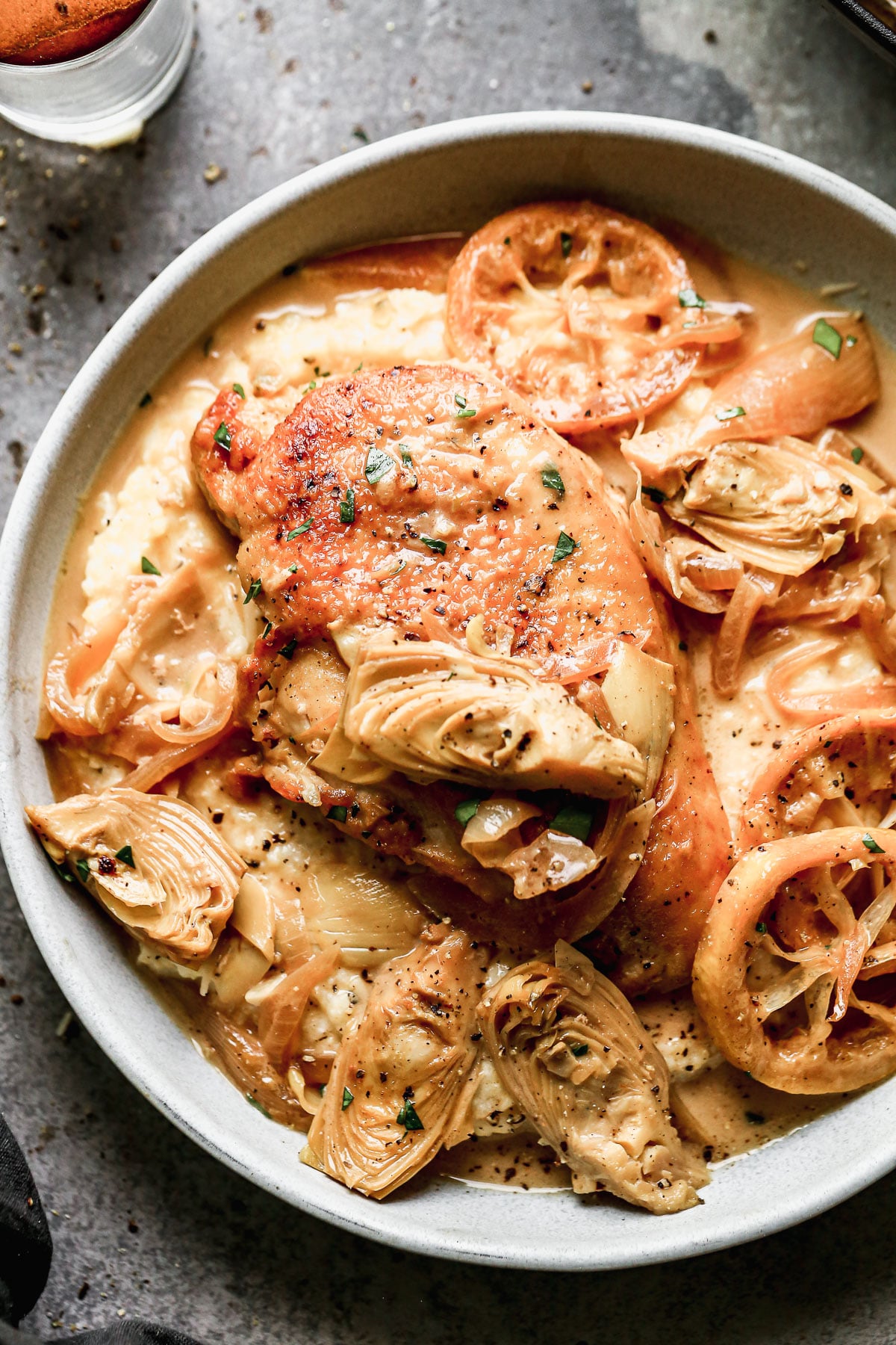 Swimming in a luscious lemon-infused wine sauce and studded with briny artichokes and sweet caramelized onions, our Chicken with Artichokes is the perfect bright springy dish to whip up when we also need a little cozy for those curve ball cold days we all get this time of year.&nbsp;