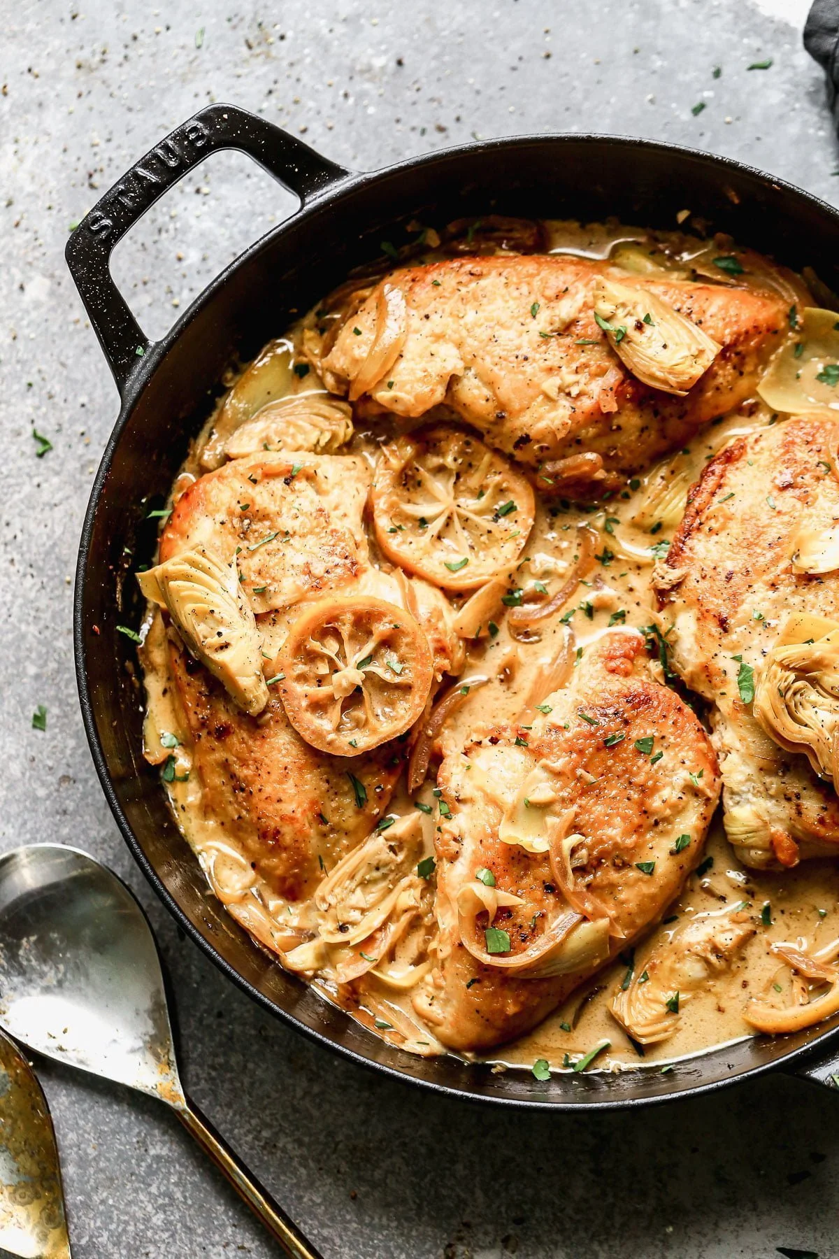 Swimming in a luscious lemon-infused wine sauce and studded with briny artichokes and sweet caramelized onions, our Chicken with Artichokes is the perfect bright springy dish to whip up when we also need a little cozy for those curve ball cold days we all get this time of year. 