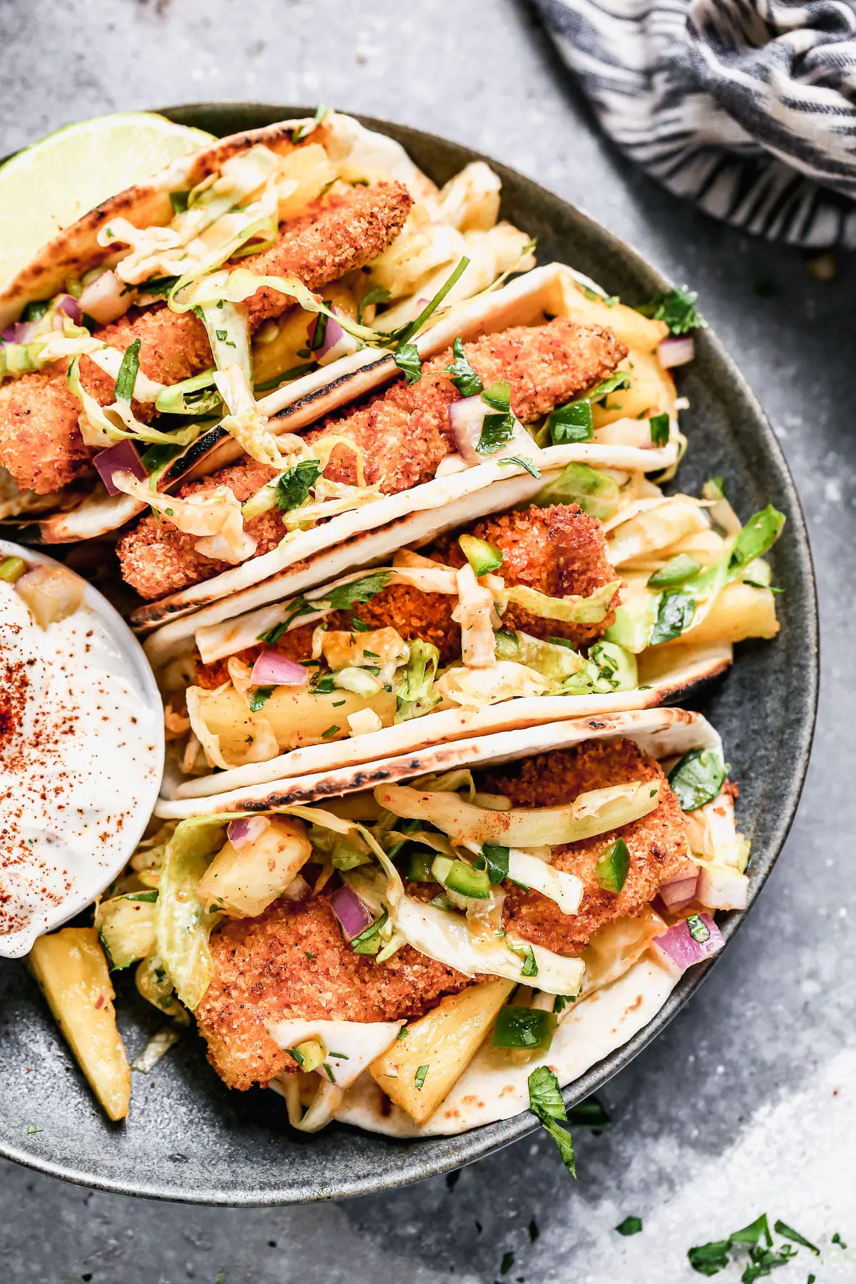 Ultra crispy breaded fish filets nestled into charred flour tortillas and topped with a sweet and spicy pineapple slaw, our Air Fryer Tacos are sure to be your new favorite taco. 