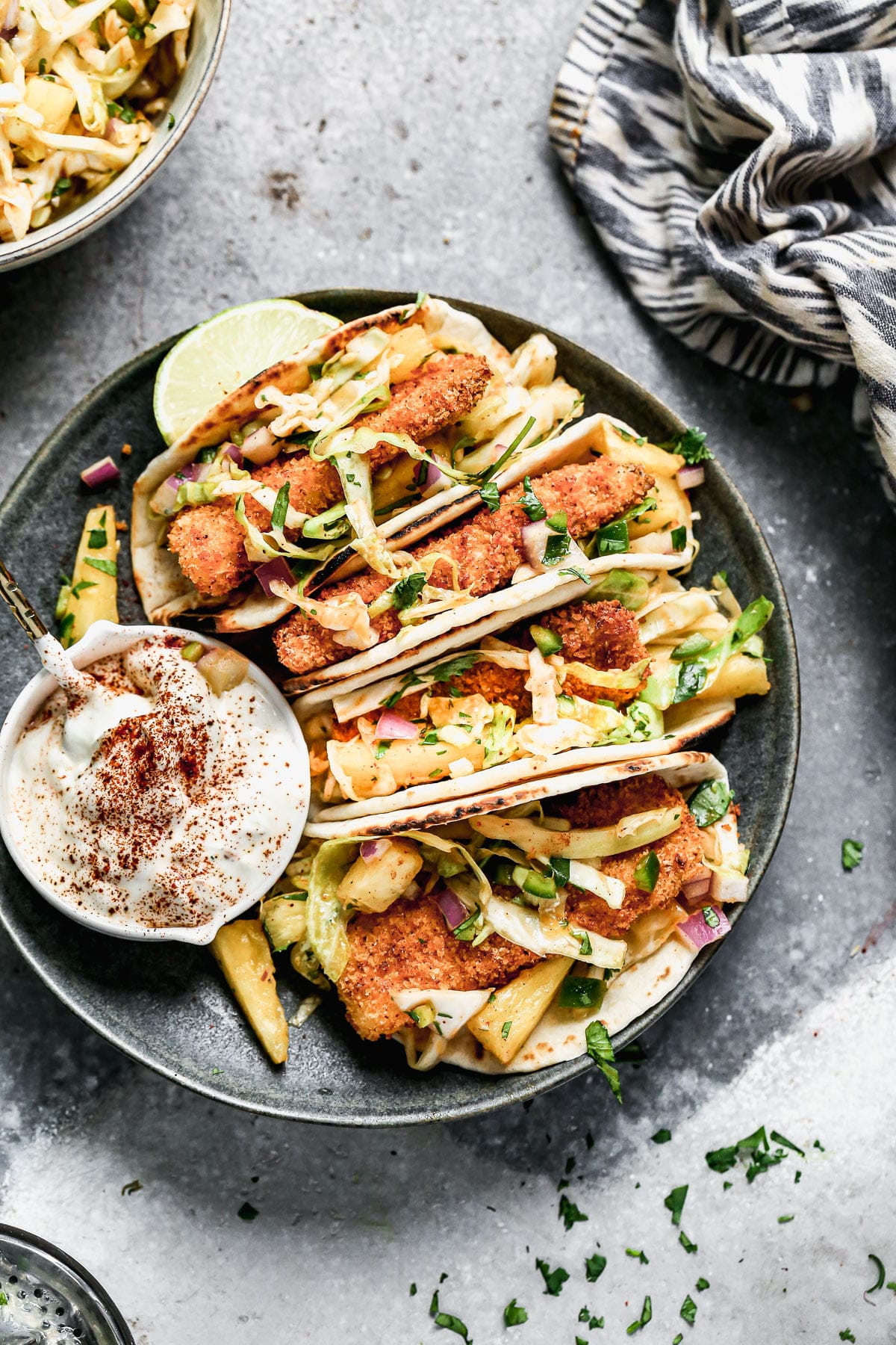 Never have a soggy fish taco again! Our Air Fryer Fish Tacos produce the CRISPIEST breaded fish without all the fat and calories and WITH all the flavor. We nestle the crunchy barramundi in charred street taco tortillas, top with a quick pineapple slaw, and a fresh squeeze of lime juice. 