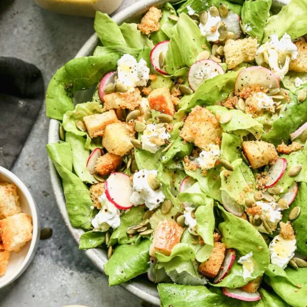 The most delicious Butter Lettuce Salad! Filled with creamy goat cheese, salty homemade croutons, radish, and pepiista seeds. Super easy and goes with everything!