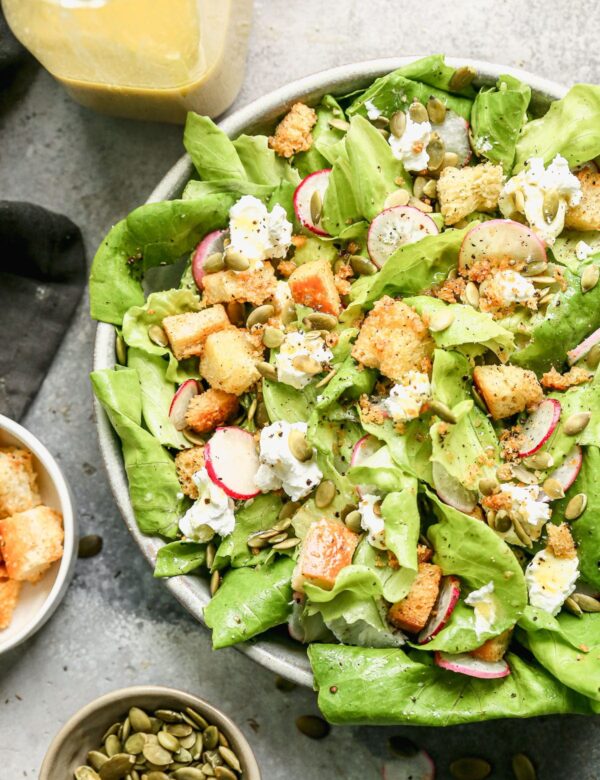 The most delicious Butter Lettuce Salad! Filled with creamy goat cheese, salty homemade croutons, radish, and pepiista seeds. Super easy and goes with everything!