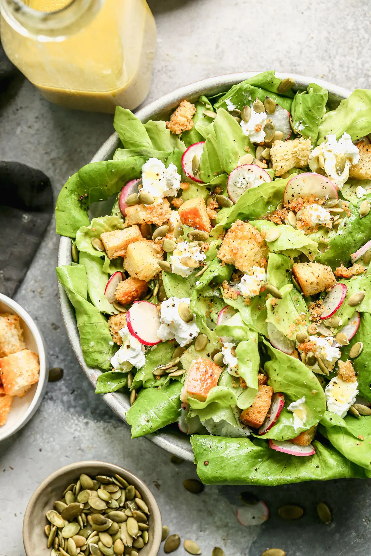 The most delicious Butter Lettuce Salad! Filled with creamy goat cheese, salty homemade croutons, radish, and pepiista seeds. Super easy and goes with everything! 