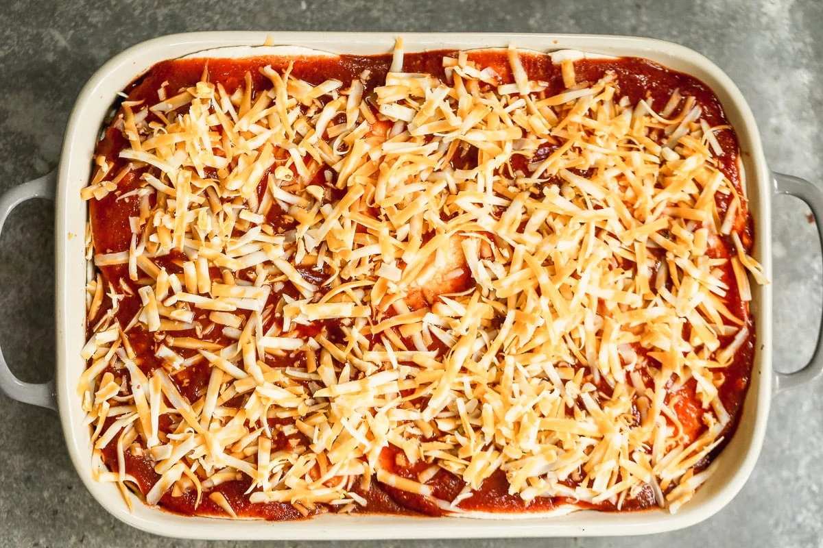 Cover with enchilada sauce and cheese