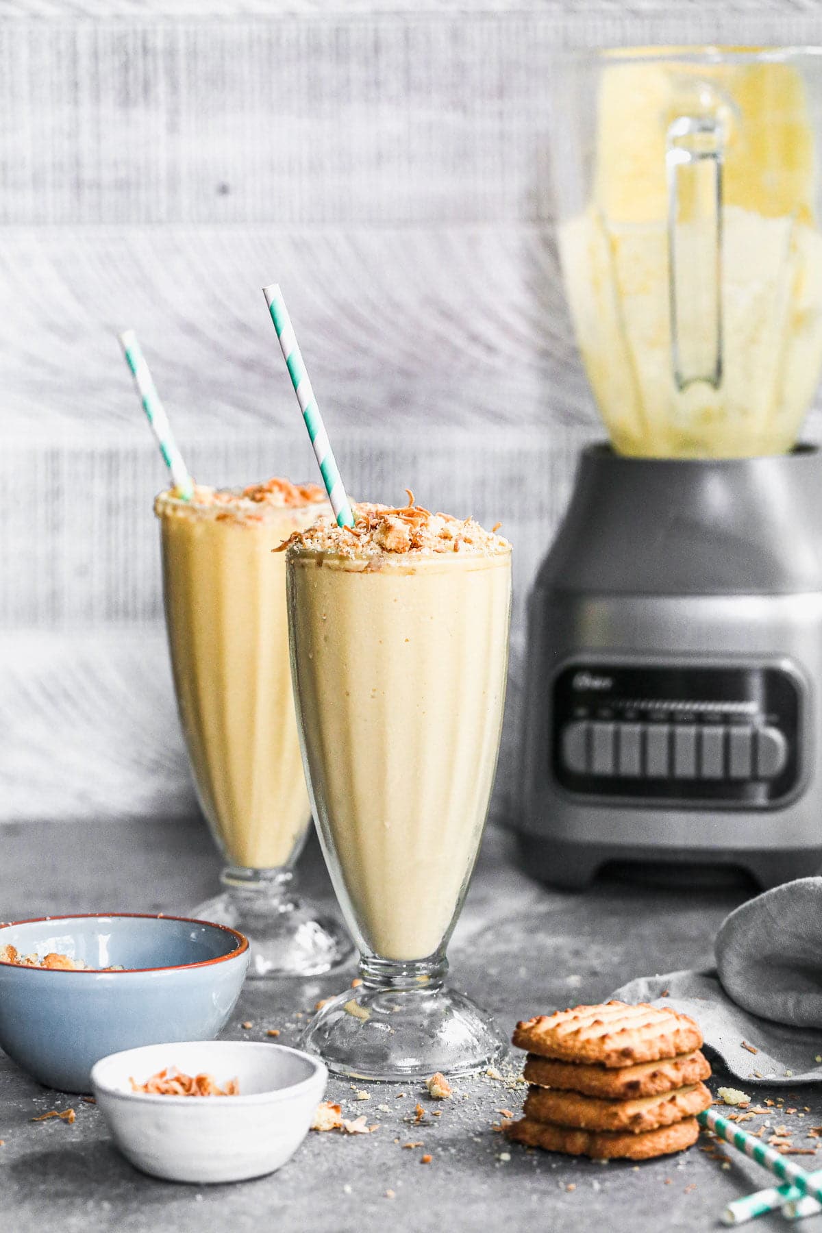 We're celebrating Oster's 75th Blending Anniversary with a Tropical Smoothie worthy of any special occasion. Filled with all your favorite tropical flavors - pineapple, mango, and coconut - this easy-to-throw-together smoothie turned dessert is irresistibly sweet, brimming with beach vibes and here to party. We top each ultra smooth, cold smoothie with toasted coconut and crushed shortbread cookies for the perfect play on texture. Don't miss this one! 