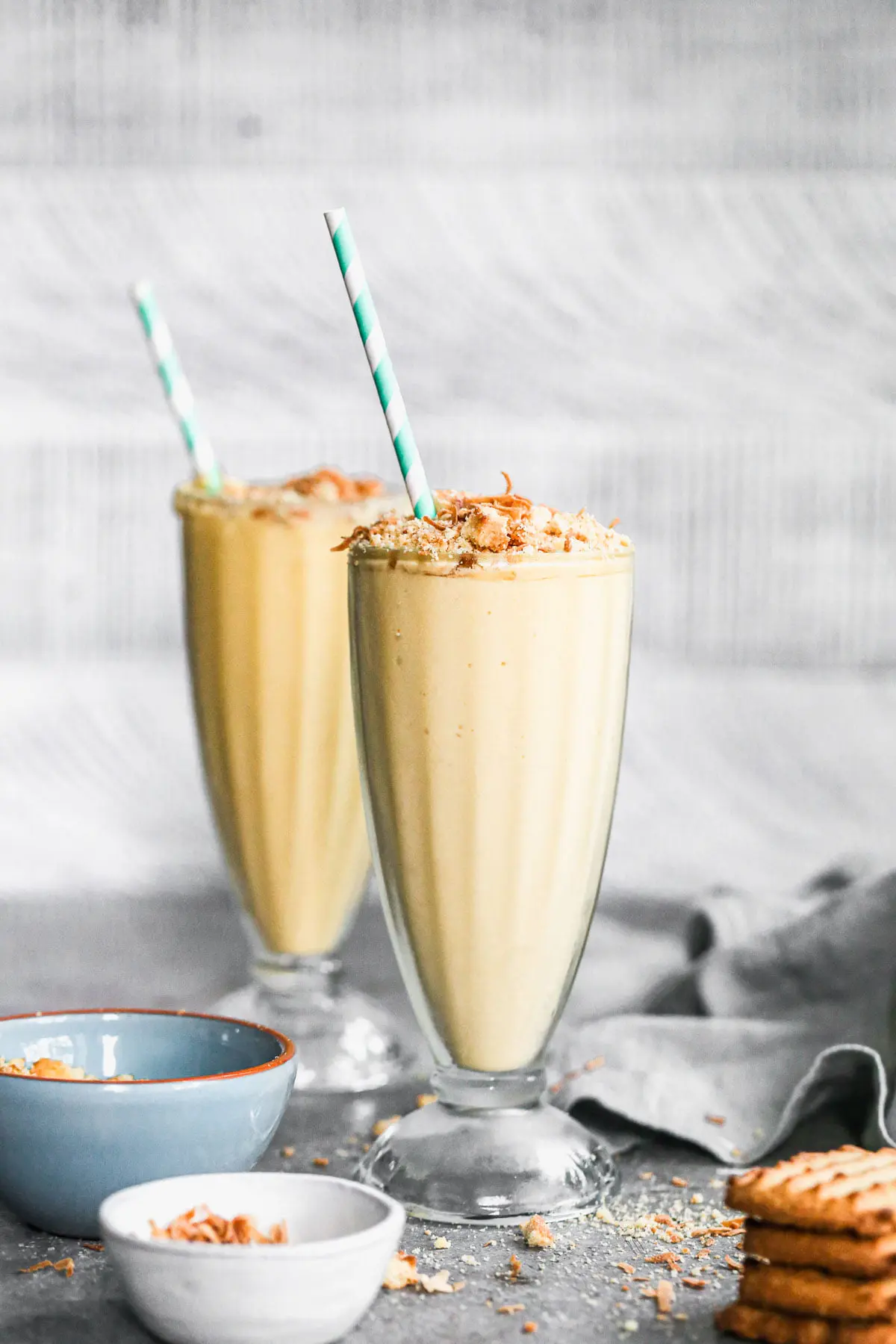 We're celebrating Oster's 75th Blending Anniversary with a Tropical Smoothie Recipe worthy of any special occasion. Filled with all your favorite tropical flavors - pineapple, mango, and coconut - this easy-to-throw-together smoothie turned dessert is irresistibly sweet, brimming with beach vibes and here to party. We top each ultra smooth, cold smoothie with toasted coconut and crushed shortbread cookies for the perfect play on texture. Don't miss this one! 