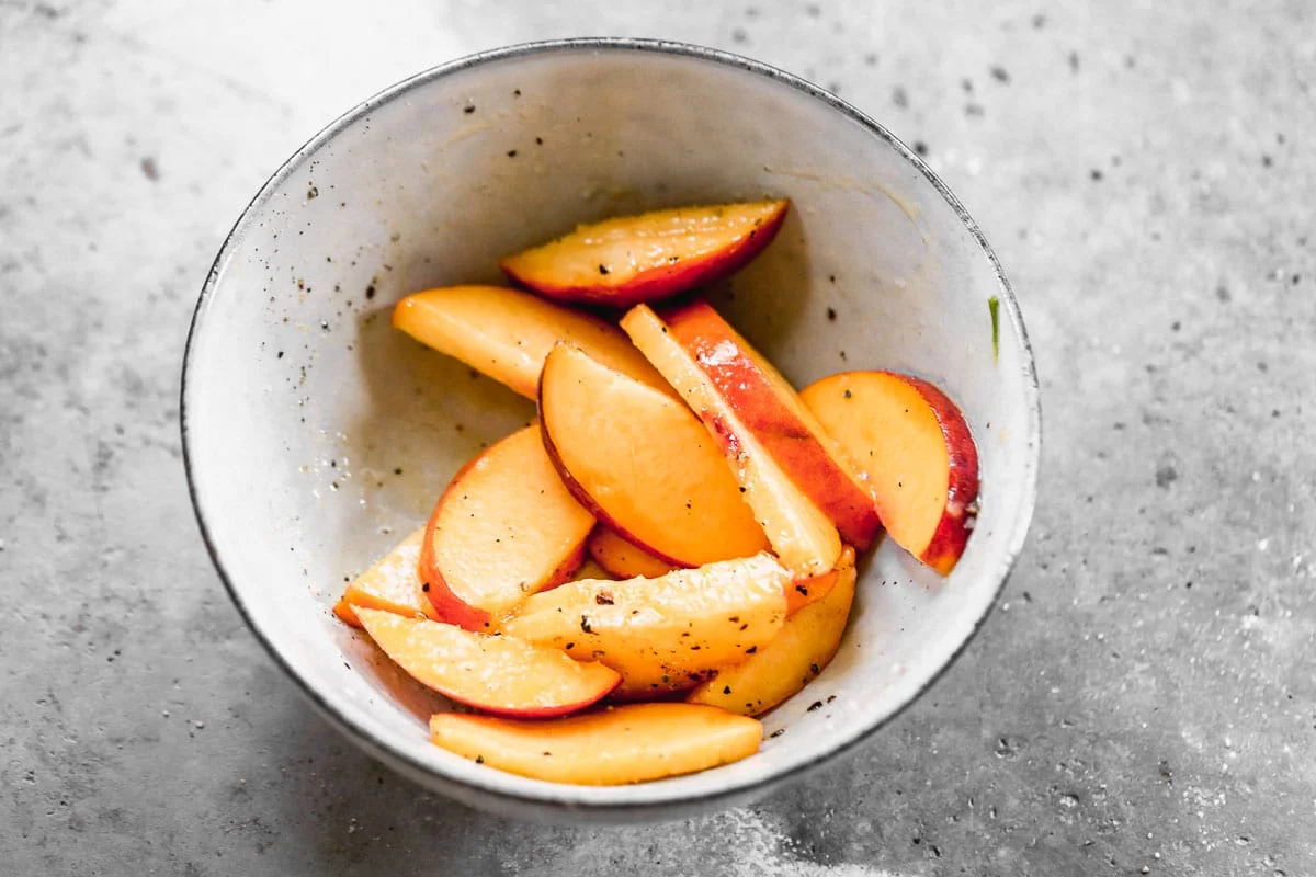 Slice peaches and sprinkle with salt and pepper