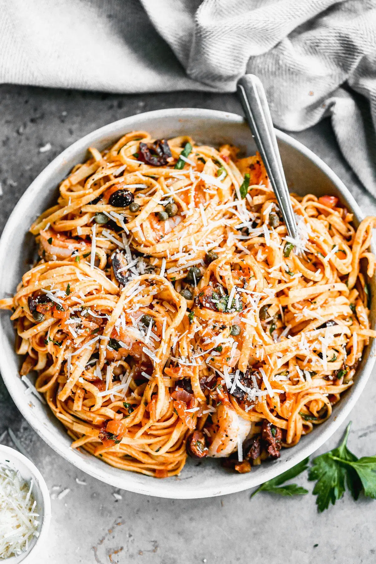 A classic pasta - shrimp puttanesca - showcases all the thing I love about the Mediterranean diet. Fresh linguine noodles are tossed with a impossibly simple tomato infused white wine sauce and studded with briny, salty capers and olives. With a heavy hand of garlic and a sprinkling of freshly grated parmesan cheese, this easy pasta dish manages to be utterly delicious and light and healthy at the same time.&nbsp;