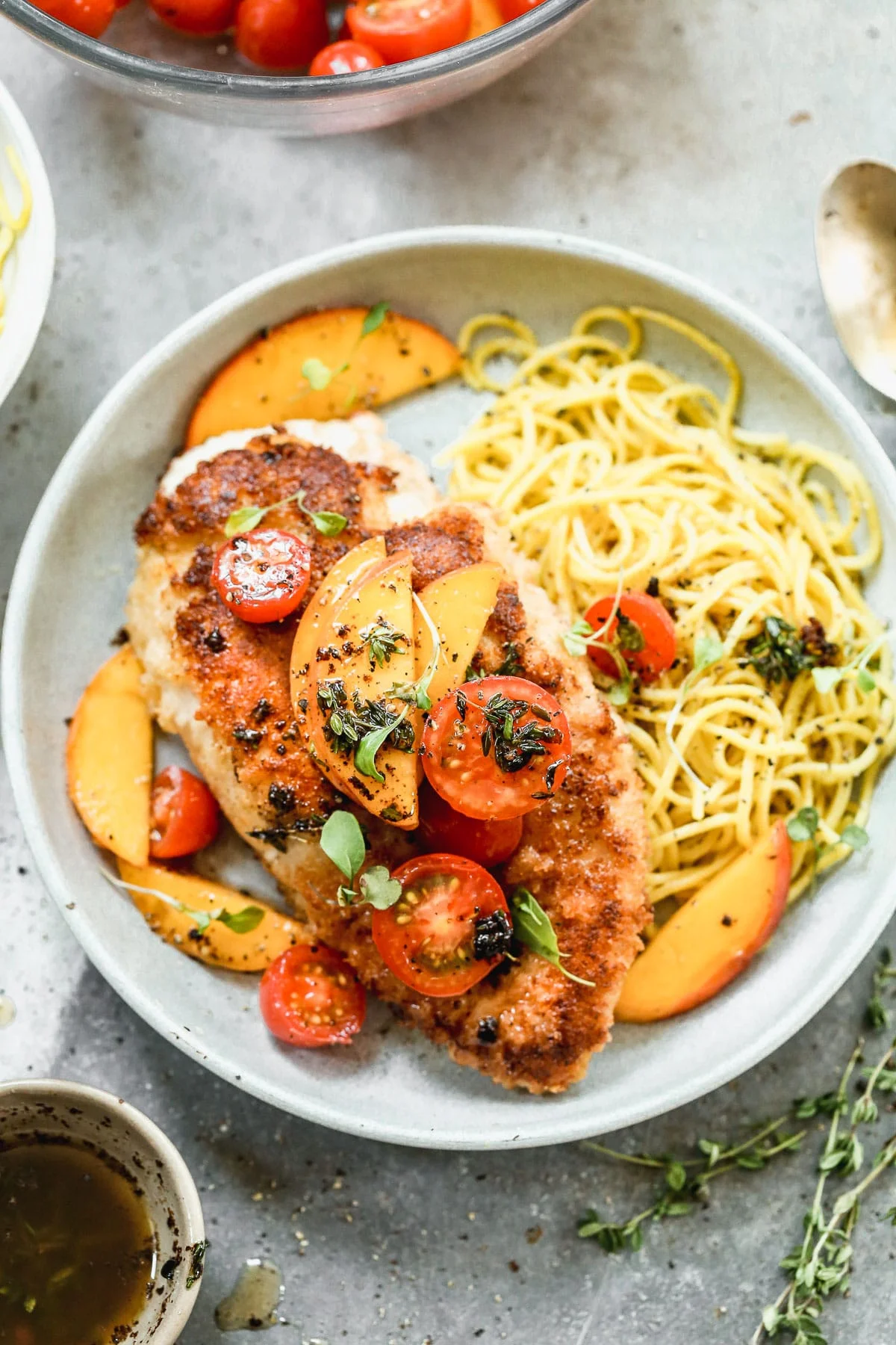 If summer were showcased on a plate it would surely be in the form of our Mozzarella-Stuffed Peach Chicken. This ultra crispy on the exterior, cheesy and tender on the interior winner of a chicken dish is adorned with the sweetest peaches and tomatoes and then drizzled with an intoxicating combination of brown butter, thyme, and lemon.&nbsp;You don't want to miss it!