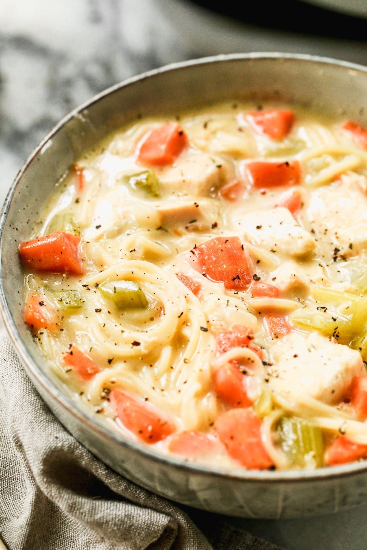 Crack Chicken Noodle Soup is cheesy, full of tangy ranch-inspired flavor and swirled with slurp-worthy angel hair pasta. Definitely not your typical bowl of chicken and noodles. 