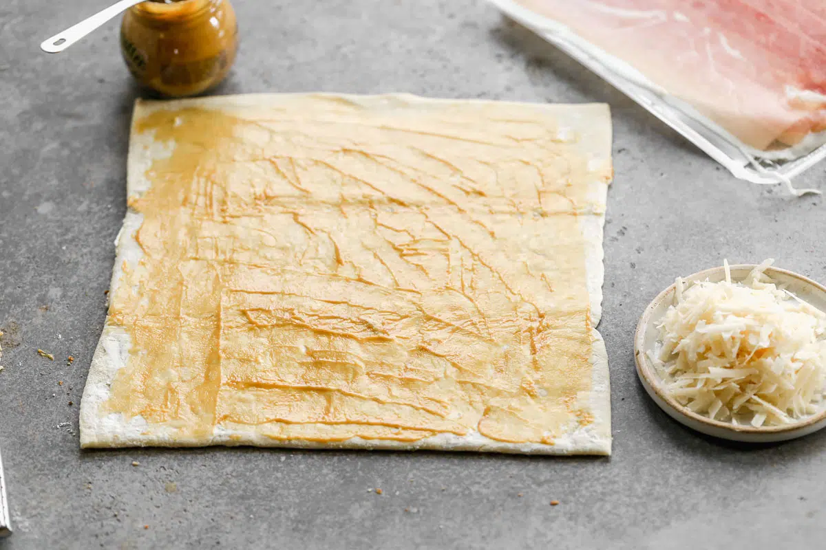 Brush puff pastry with mustard