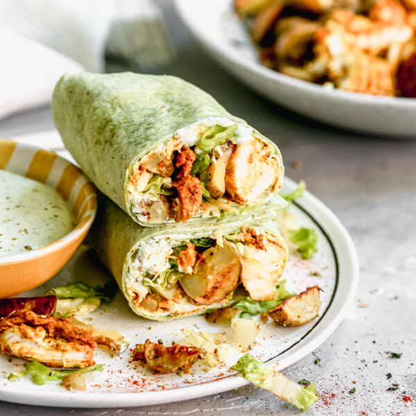 Chicken Shawarma Wraps are filled with tender, flavorful chicken and crispy potatoes then smothered in garlicky Greek yogurt sauce, lettuce and tomatoes.