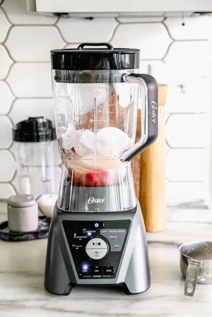 Add ice, raspberries, lemon juice, and simple syrup to the blender. 