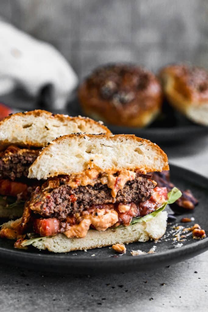 Our Pimento Cheeseburgers are the perfect way to gussy up your next backyard barbecue. We season all-beef patties simply with salt, pepper and Worcestershire sauce grill them and then generously smother them with homemade pimento cheese, crispy bacon, lettuce and tomato, then sandwich it between at buttery "everything" brioche bun. Simple and so delicious. 
