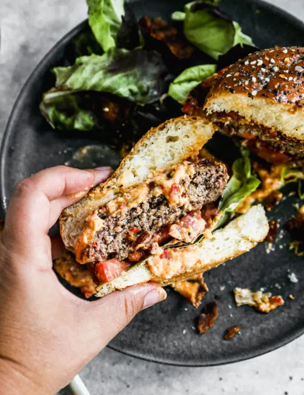 Our Pimento Cheeseburgers are the perfect way to gussy up your next backyard barbecue. We season all-beef patties simply with salt, pepper and Worcestershire sauce grill them and then generously smother them with homemade pimento cheese, crispy bacon, lettuce and tomato, then sandwich it between at buttery "everything" brioche bun. Simple and so delicious.