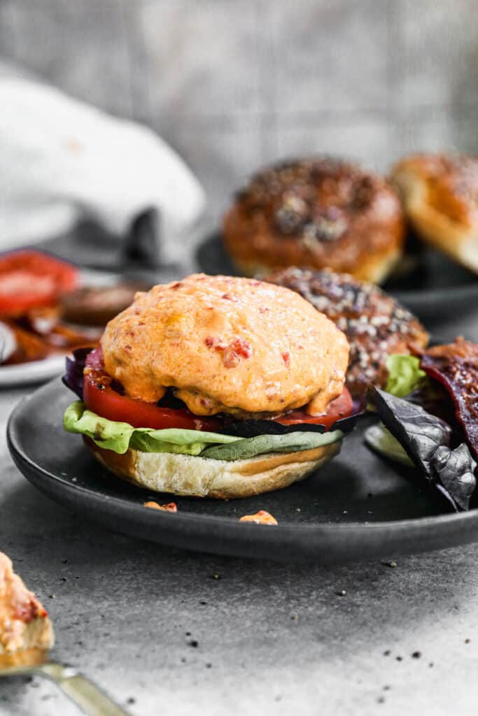Our Pimento Cheeseburgers are the perfect way to gussy up your next backyard barbecue. We season all-beef patties simply with salt, pepper and Worcestershire sauce grill them and then generously smother them with homemade pimento cheese, crispy bacon, lettuce and tomato, then sandwich it between at buttery &quot;everything&quot; brioche bun. Simple and so delicious. 