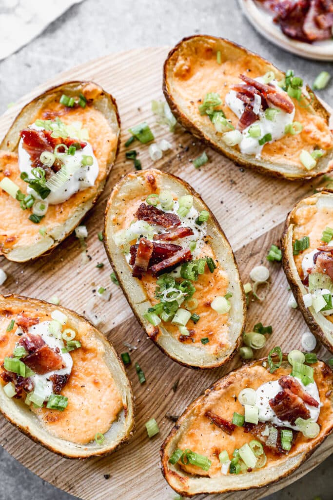 Air Fryer Potato Skins Stuffed with gooey pimento cheese, creme fraiche, crispy bacon and a sprinnkling of chives. 