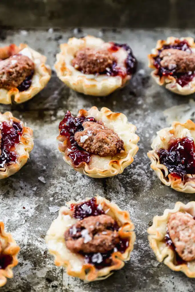 Brimming with melty brie, sweet jam and topped with a crunchy candied pecan, our brie bites will be the hit of any party!