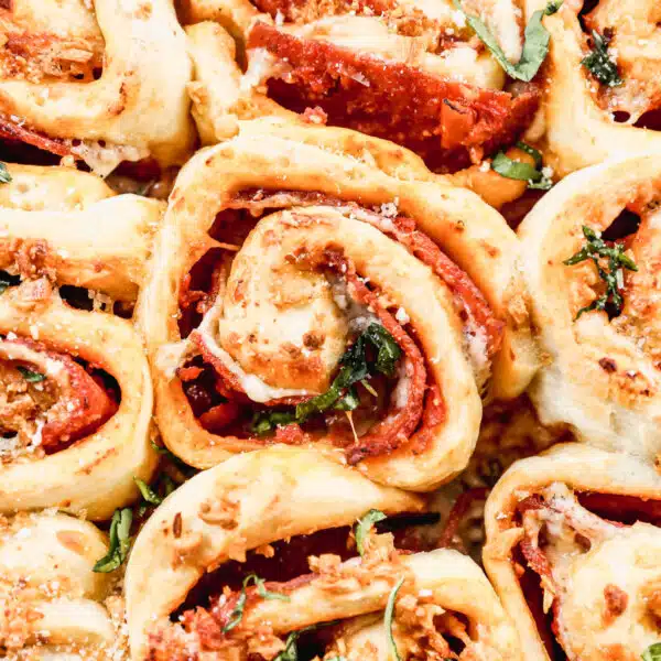 Our Pepperoni Roll recipe is the ultimate pizza snack! Layers of pillow-y dough, pizza sauce, pepperoni and gooey cheese all topped off with garlic butter.