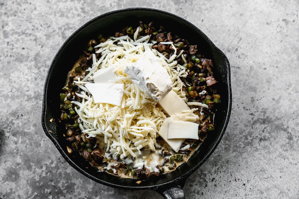 Provolone,, mozzarella and American cheese with seared beef and peppers