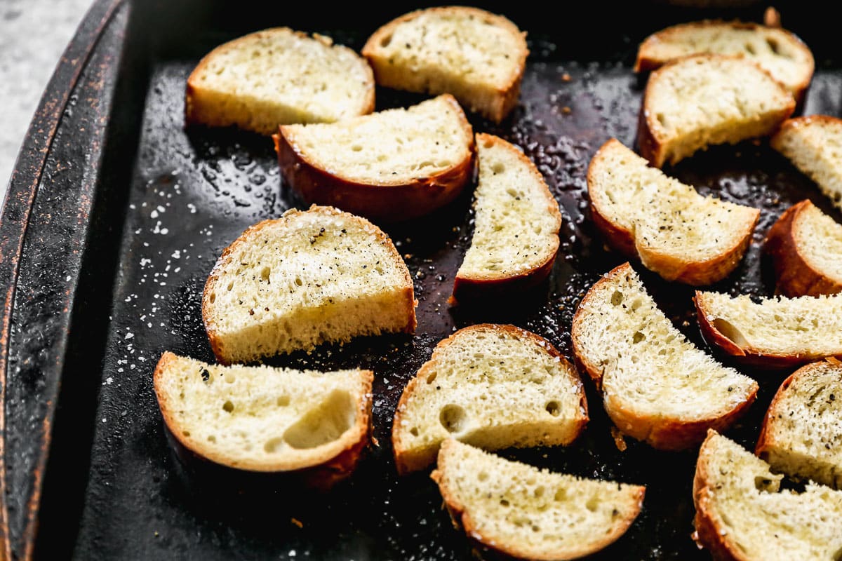 Toasted crostini on baking sheet