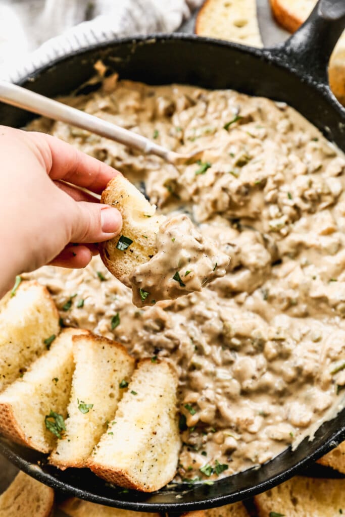 This Philly Cheesesteak Dip is SINFULLY delicious. This easy dip is packed with crispy steak, tangy provolone cheese, mozzarella, and gooey white American cheese. It’s studded with green peppers, mushrooms, and a creamy sauce, you can’t resist.