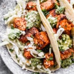 Stuffed with buttery blackened salmon bites and shredded cabbage then drizzled with a luscious Jalapeño cilantro Crema and crumbled Cotija cheese, our salmon tacos are sure to hit the seafood spot.