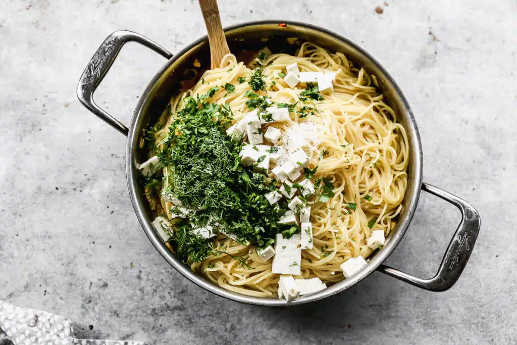 Angel hair pasta with fresh dill, parsley, feta, salt and pepper.