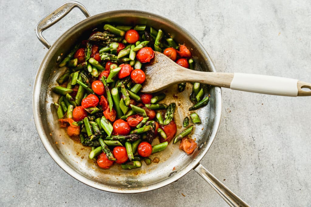 asparagus and cherry tomatoes in a pan