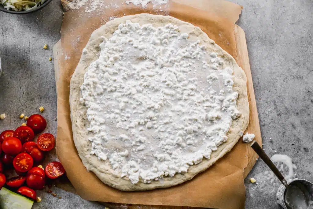 Cottage Cheese on unbaked pizza dough crust