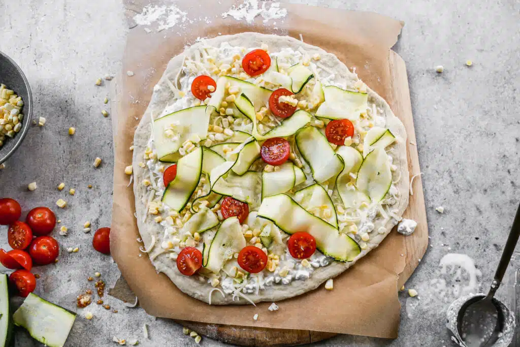 Cottage cheese, summer veggies on an unbaked pizza crust