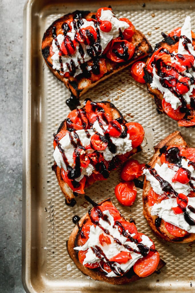 Charred sourdough bread smothered with burst cherry tomatoes, creamy cool burrata and drizzled with luscious balsamic glaze are all makings of the perfect summer appetizer - Burrata Toast.