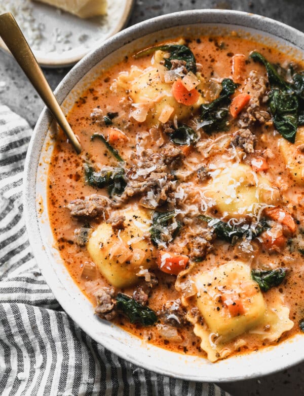 A play on penne alla vodka and classic tortellini soup, this tomato-based ravioli soup studded with sweet Italian sausage, crisp carrots and tender cheese ravioli is a meal every single person in my family will inhale in a heartbeat.