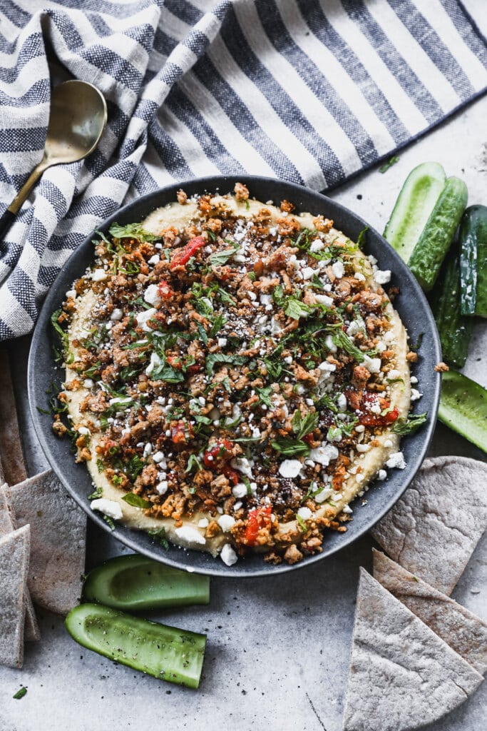 Layered with store-bought hummus, a mediterranean-spiced ground chicken mixture, feta and mint then topped with hot honey, this Loaded Hummus in the new way to crudités.