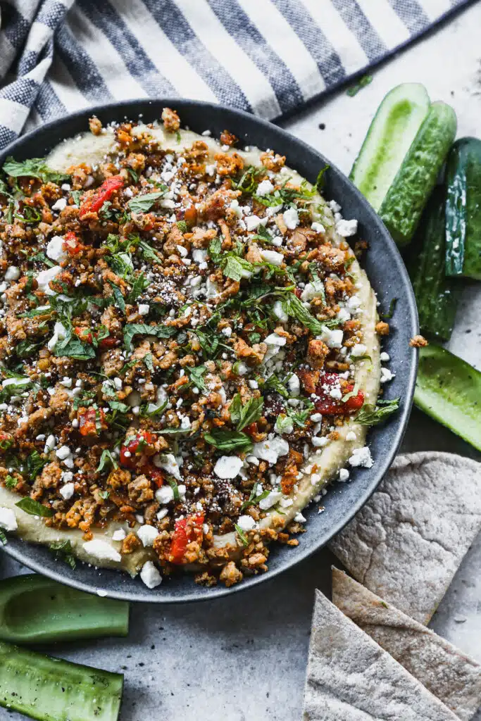 Layered with store-bought hummus, a mediterranean-spiced ground chicken mixture, feta and mint then topped with hot honey, this Loaded Hummus in the new way to crudités.