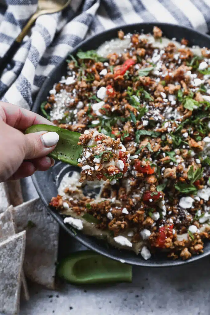 Layered with store-bought hummus, a mediterranean-spiced ground chicken mixture, feta and mint then topped with hot honey, this Loaded Hummus in the new way to crudités.