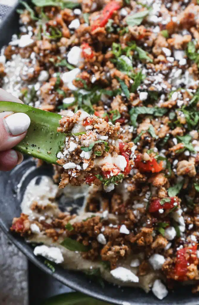 Layered with store-bought hummus, a mediterranean-spiced ground chicken mixture, feta and mint then topped with hot honey, this Loaded Hummus in the new way to crudités.