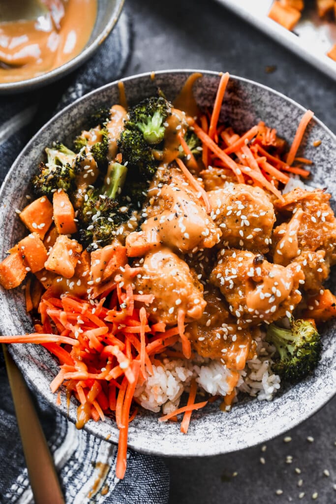 Packed with crispy Chic-Fil-A inspired nuggets coated in a tangy Korean style sauce, charred roasted broccoli, creamy sweet potato, and crunchy carrot, then served over nutty brown rice, these bowls are healthy, filling and crazy delicious.