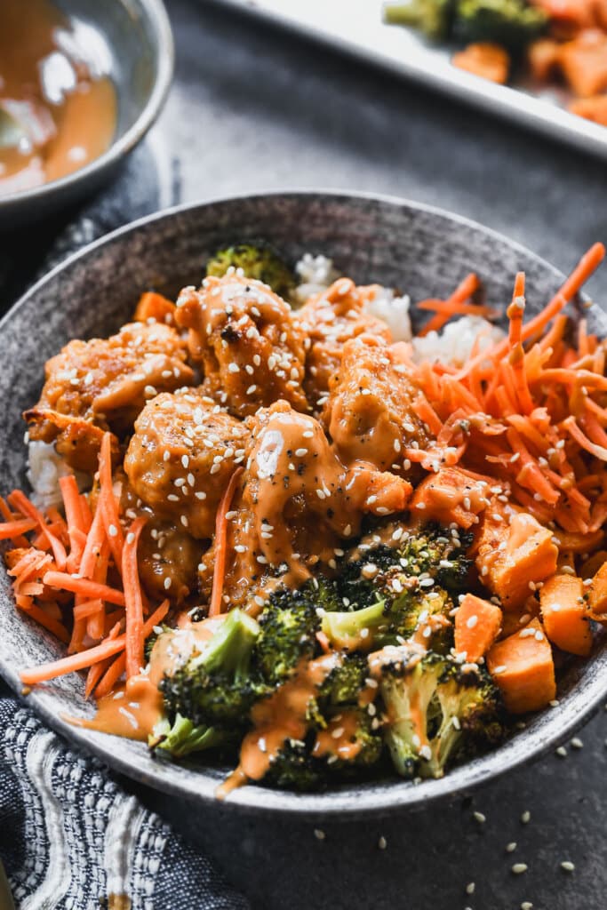 Packed with crispy Chic-Fil-A inspired nuggets coated in a tangy Korean style sauce, charred roasted broccoli, creamy sweet potato, and crunchy carrot, then served over nutty brown rice, these bowls are healthy, filling and crazy delicious.