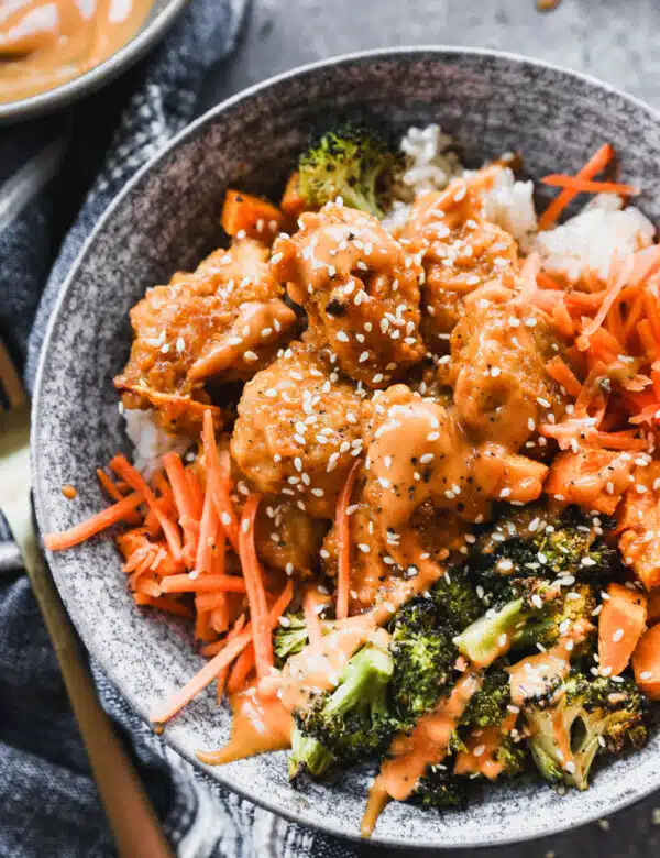 Packed with crispy Chic-Fil-A inspired nuggets coated in a tangy Korean style sauce, charred roasted broccoli, creamy sweet potato, and crunchy carrot, then served over nutty brown rice, these bowls are healthy, filling and crazy delicious.