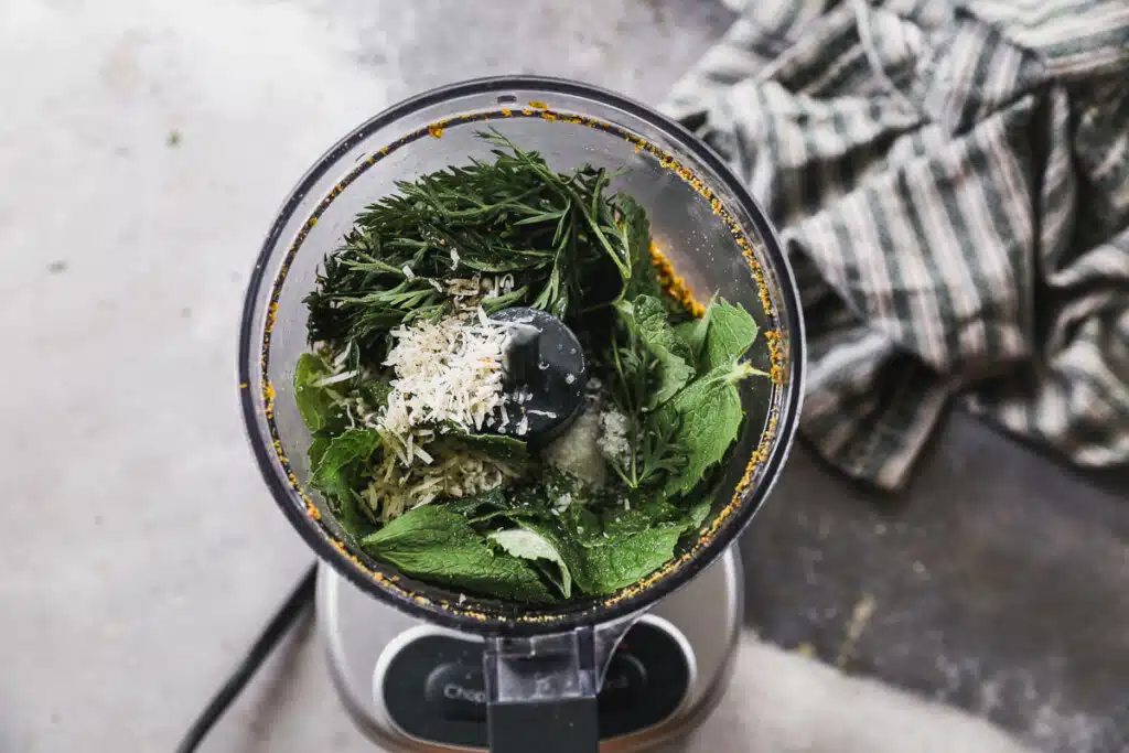 Mint, carrot top, cheese and pistachios in a mini food processor.