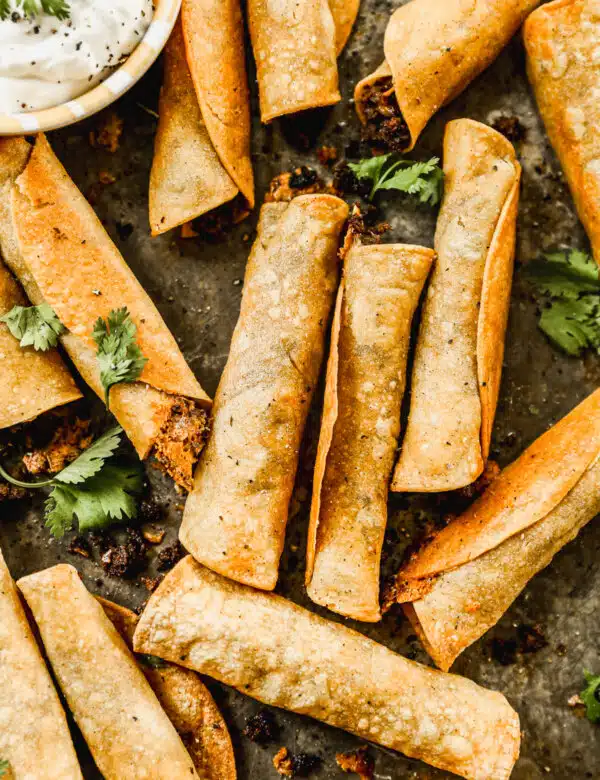 Taco-flavored ground beef and melty cheddar cheese stuffed in corn tortillas and baked into a crunchy, cheesy snack nirvana. The perfect quick and easy dinner or after school all without the fuss of frying.