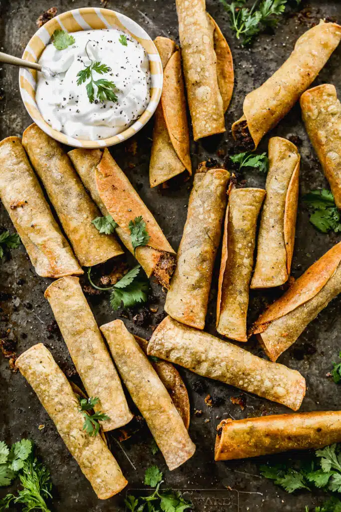 Taco-flavored ground beef and melty cheddar cheese stuffed in corn tortillas and baked into a crunchy, cheesy snack nirvana. The perfect quick and easy dinner or after school all without the fuss of frying.